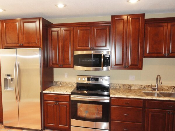 Wood-stained-raised-panel-kitchen-cabinets